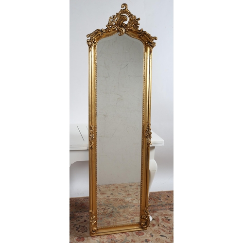 739 - A CONTINENTAL GILT FRAME MIRROR the rectangular arched bevelled glass plate within a foliate moulded... 