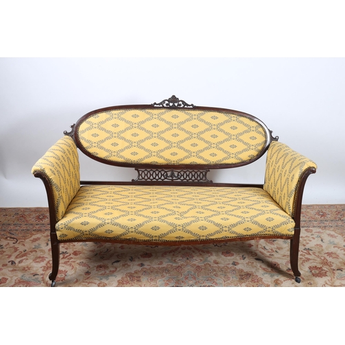9 - A VINTAGE MAHOGANY AND UPHOLSTERED SETTEE the oval upholstered back with pierced carved cresting wit... 