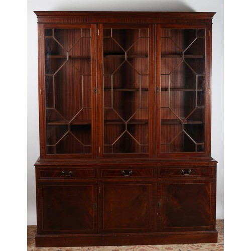 823 - A GEORGIAN DESIGN mahogany bookcase the moulded cornice above three astragal glazed doors containing... 