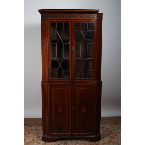 81 - AN EDWARDIAN MAHOGANY AND SATINWOOD INLAID CORNER CABINET the moulded cornice above a pair of astrag... 