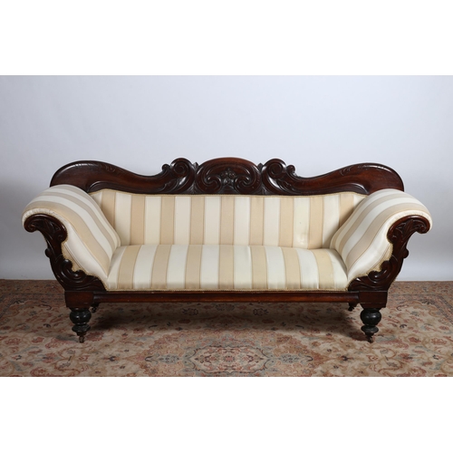 222 - A 19TH CENTURY MAHOGANY SETTEE the serpentine carved top rail above an upholstered back and seat wit... 