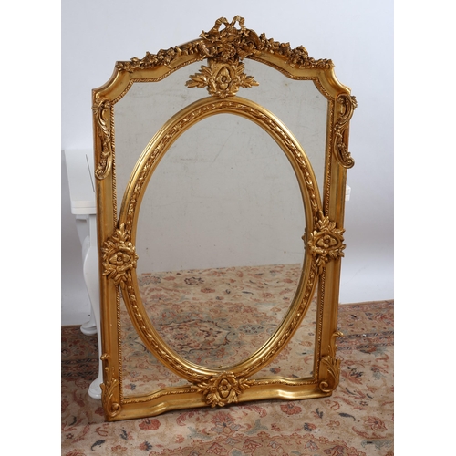 812 - A CONTINENTAL GILT FRAME COMPARTMENTED MIRROR the oval bevelled glass plate within a foliate frame w... 