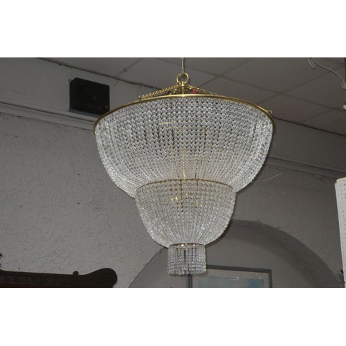 183 - A CONTINENTAL CHANDELIER of domed stepped form hung with cascading glass beads 
81cm (d)
100cm drop