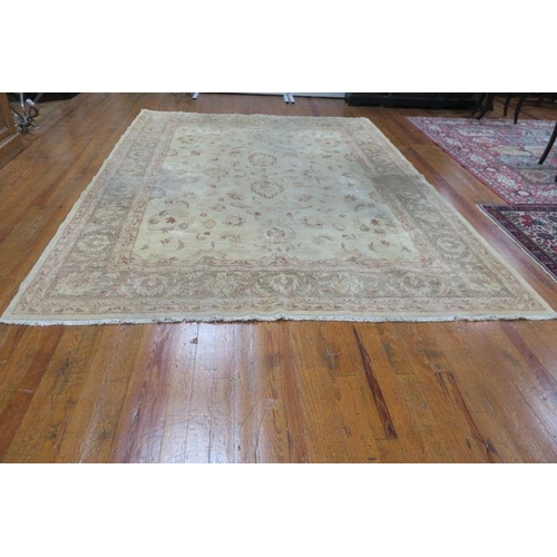 247 - A WOOL RUG the beige ground with central panel filled with stylised flowerheads and foliage within a... 