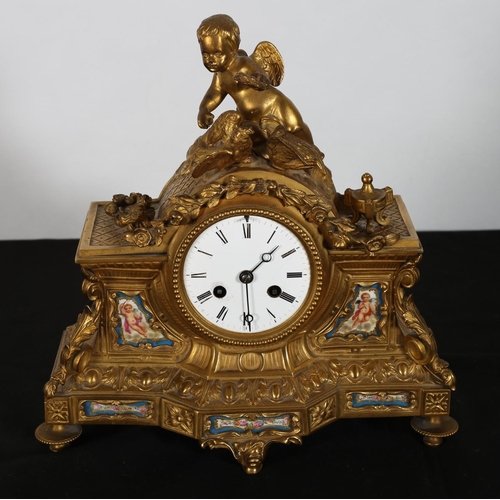 72 - A 19TH CENTURY GILT BRASS AND PORCELAIN MANTLE CLOCK the rectangular case surmounted by a winged fig... 