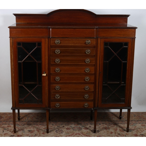 78 - A VINTAGE MAHOGANY DISPLAY CABINET of rectangular breakfront outline the shaped top above eight long... 