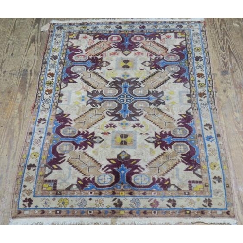 818 - AN ORIENTAL WOOL RUG the beige ground with central panel filled with serrated panels, palmets and ho... 