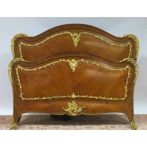 822 - A FINE 19TH CENTURY CONTINENTAL KINGWOOD AND GILT BRASS MOUNTED BED the rectangular arched headboard... 