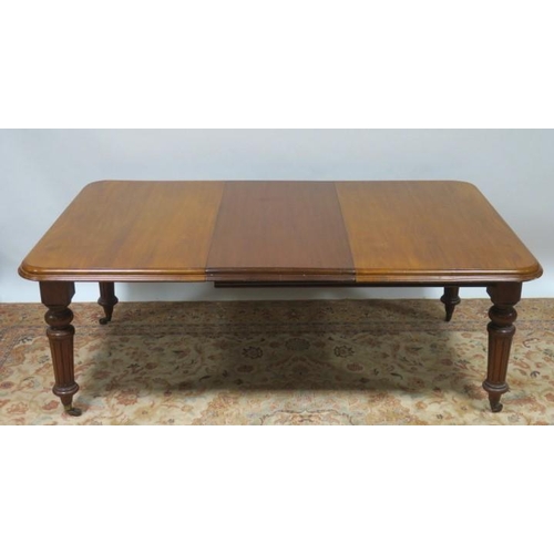 823 - A 19TH CENTURY MAHOGANY TELESCOPIC DINING TABLE of rectangular outline with rounded corners and one ... 