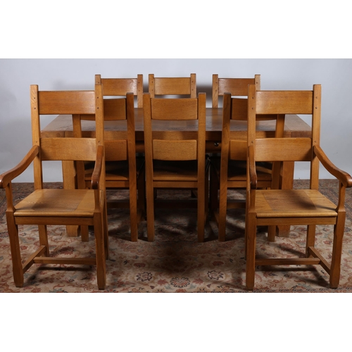 84 - A NINE PIECE OAK DINING ROOM SUITE comprising a set of eight dining chairs including a pair of elbow... 