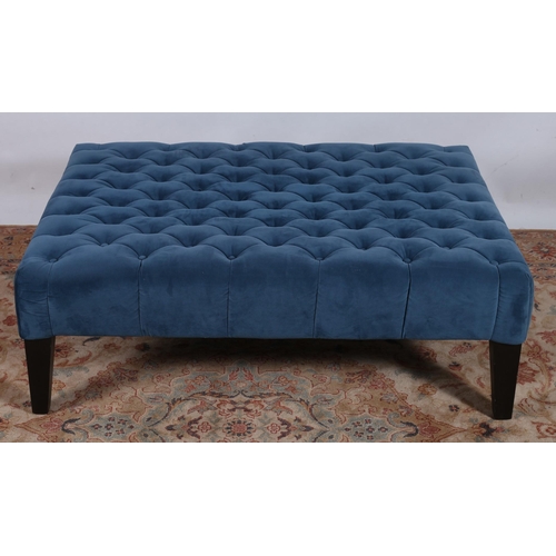 85 - A BLUE VELVET UPHOLSTERED AND EBONISED STOOL of rectangular outline with deep buttoned upholstered s... 