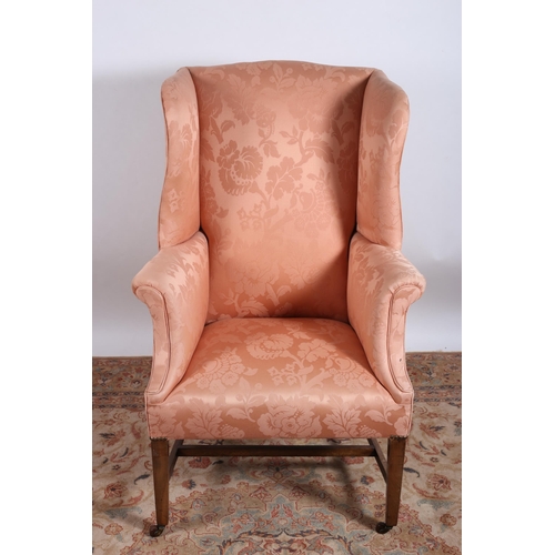 37 - A 19TH CENTURY MAHOGANY AND UPHOLSTERED WING CHAIR with scroll over arms on square tapering legs wit... 