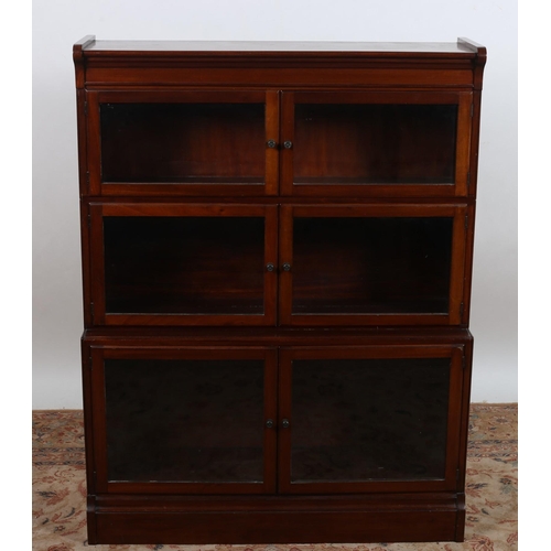 538 - A VINTAGE MAHOGANY BOOKCASE of rectangular outline the shaped top above six glazed doors containing ... 