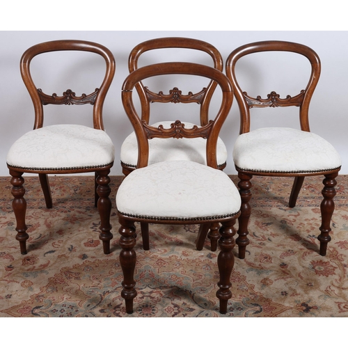 545 - A SET OF FOUR CAMPAIGN MAHOGANY DINING CHAIRS each with a curved top rail with carved splat and upho... 