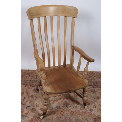 546 - A ELMWOOD ARMCHAIR the curved top rail with vertical splats and shaped arms and seat on bobbin turne... 