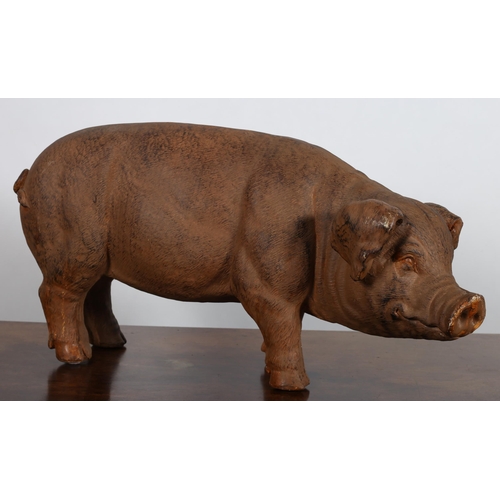 553 - A COMPOSITION FIGURE modelled as a pig shown standing 
37cm (h) x 17cm (w)