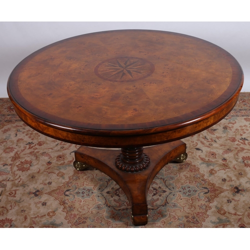 554 - A THEODORE ALEXANDER BURR WALNUT AND GILT BRASS MOUNTED TABLE the circular segmented crossbanded top... 