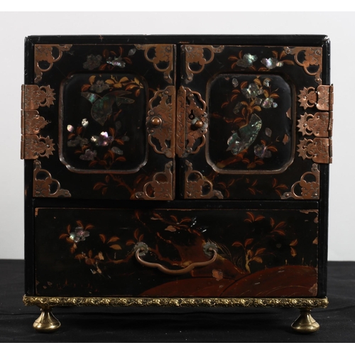 570 - A CHINESE BLACK LACQUERED AND MOTHER OF PEARL MINIATURE CHEST of rectangular outline the shaped top ... 