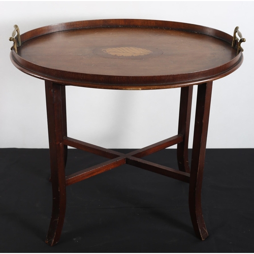 576 - A VINTAGE MAHOGANY INLAID TRAY ON STAND of oval outline the shaped top with moulded gallery and bras... 