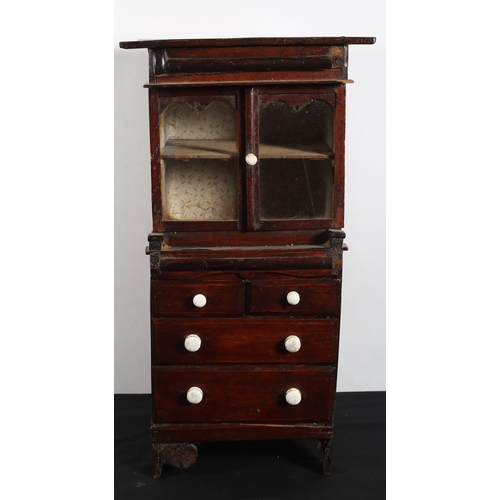 588 - A 19TH CENTURY MINIATURE PINE DRESSER the rectangular top above a pair of glazed cupboards the base ... 