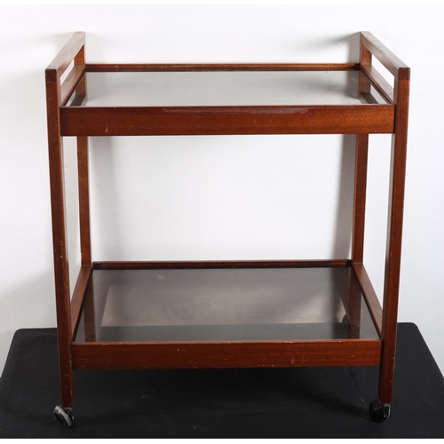 590 - A VINTAGE TEAK AND SMOKED GLASS TWO TIER SERVING TROLLEY of rectangular outline on castors
64cm (h) ... 