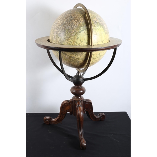 591 - A TERRESTRIAL GLOBE raised on a carved tripod support with scroll toes 
89cm (h) x 59cm (d)