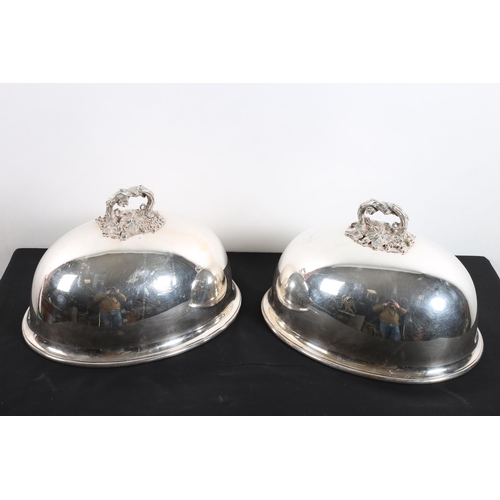 592 - A PAIR OF SILVER PLATED CRESTED DOME SHAPED DISH COVERS each with a foliate cast and fruiting vine h... 