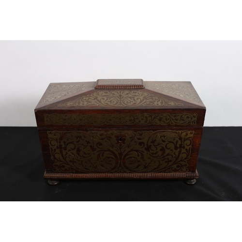 594 - A REGENCY ROSEWOOD AND BRASS INLAID TEA CADDY of sarcophagus outline the hinged lid containing a lid... 