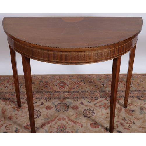 739 - A SHERATON DESIGN MAHOGANY AND SATINWOOD INLAID TABLE of demi lune outline the shaped top raised on ... 