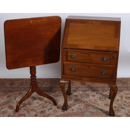 740 - A MAHOGANY CROSSBANDED BUREAU the hinged writing slope containing pigeon holes and drawer above two ... 