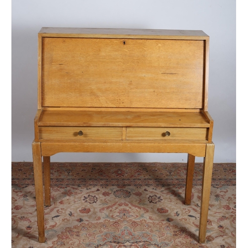 751 - A VINTAGE STAINED BEECHWOOD WRITING DESK the rectangular top above a hinged compartment containing s... 