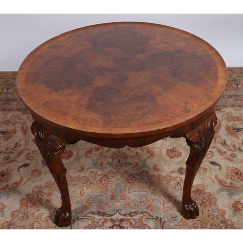 124 - A BURR WALNUT CROSSBANDED AND MAHOGANY COFFEE TABLE the circular dish top on carved cabriole legs wi... 