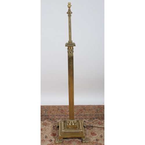 127 - A HEAVY BRASS FLOOR STANDARD LAMP the reeded cylindrical column raised on a square stepped base with... 