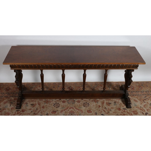 97 - A GOTHIC DESIGN WALNUT AND MAHOGANY SIDE TABLE of rectangular outline with gadrooned frieze on stand... 