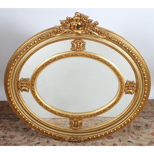 848 - A CONTINENTAL GILT FRAME MIRROR of oval outline with bevelled glassplate within a foliate decorated ... 