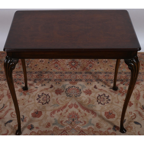 114 - A VINTAGE WALNUT OCCASIONAL TABLE of rectangular outline and shaped top on cabriole legs with pad fe... 