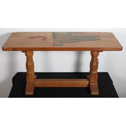 170 - A MOUSEMAN VINTAGE OAK COFFEE TABLE of rectangular outline the shaped top raised on baluster support... 