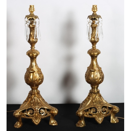 171 - A PAIR OF CONTINENTAL GILT BRASS TABLE LAMPS each on baluster form hung with faceted pendants raised... 