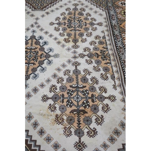 265 - A TUNISIAN WOOL RUG the cream, light brown and coffee ground with central panel filled with serrated... 