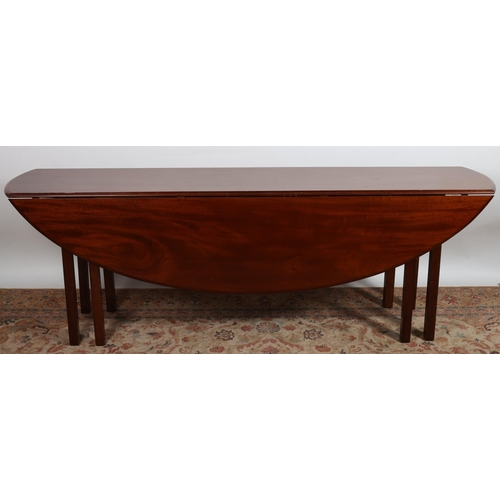 361 - A GEORGIAN DESIGN MAHOGANY HUNTING TABLE of oval outline the shaped hinged top raised on eight squar... 