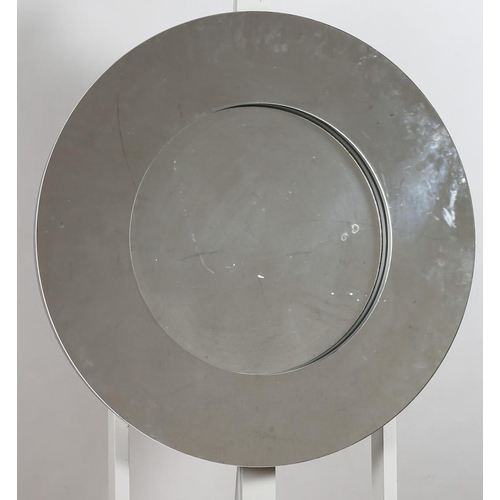 38 - A CONTEMPORARY MIRROR the circular bevelled glass plate within a black glass border with faceted stu... 