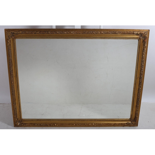 46 - A GILT FRAME MIRROR WITH RECTANGULAR BEVEL GLASS PLATE with bead work and foliate moulded frame
111 ... 