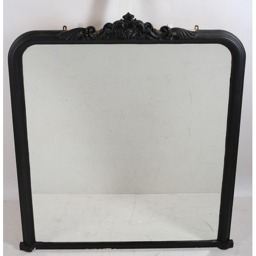 49 - A CONTEMPORARY EBONISED AND GILT FRAME MIRROR the rectangular beveled glass plate with a gilt slip w... 