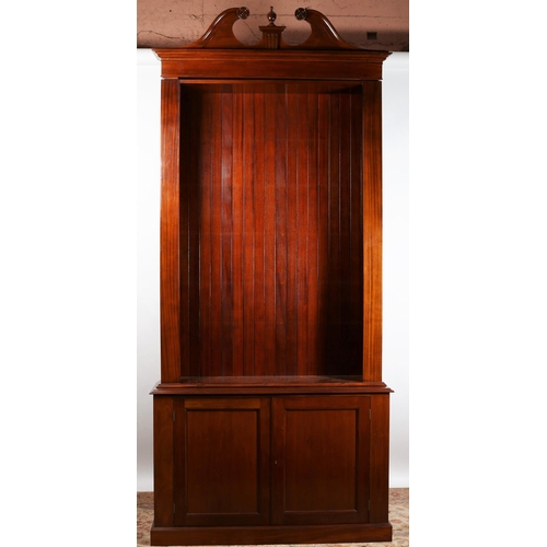 66 - A GEORGIAN DESIGN MAHOGANY OPEN FRONT BOOKCASE the architectural pediment above four adjustable shel... 