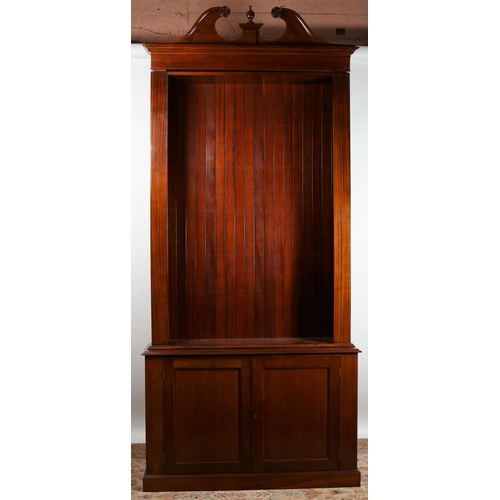 67 - A GEORGIAN DESIGN MAHOGANY OPEN FRONT BOOKCASE the architectural pediment above four adjustable shel... 