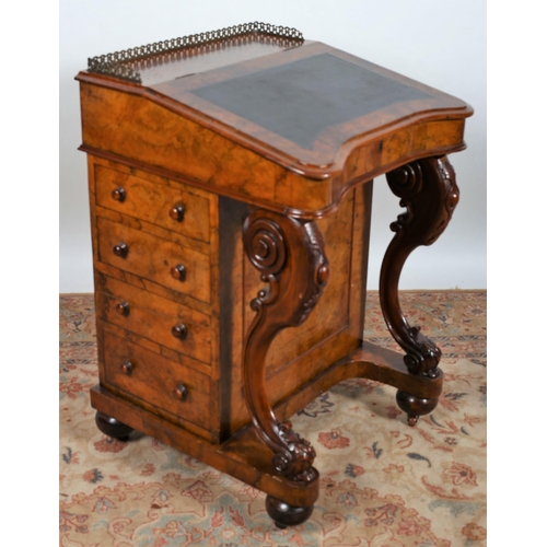 69 - A 19TH CENTURY BURR WALNUT DAVENPORT the superstructure with pierced brass gallery above a hinged wr... 