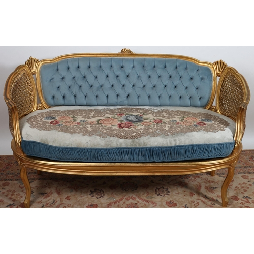 72 - A CONTINENTAL GILTWOOD AND UPHOLSTERED SETTEE the moulded frame with flowerhead and foliate cresting... 