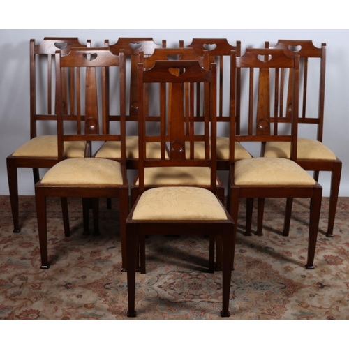 75 - A SET OF EIGHT VINTAGE WALNUT DINING CHAIRS each with a shaped pierced top rail  with vertical splat... 