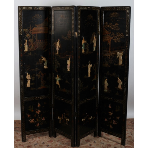 76 - A CHINESE BLACK LACQUERED AND POLYCHROME FOUR FOLD SCREEN overlaid with semi precious stones depicti... 