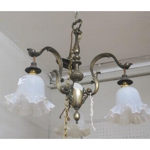 839 - A VINTAGE GILT METAL THREE BRANCH CHANDELIER the baluster column issuing three foliate cast scroll a... 